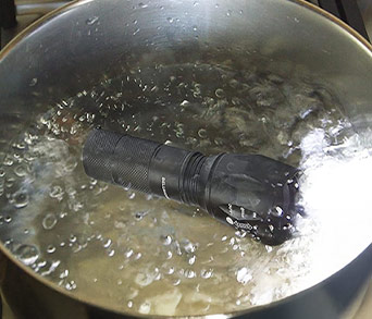 Tac Light working in a pot of boiling water